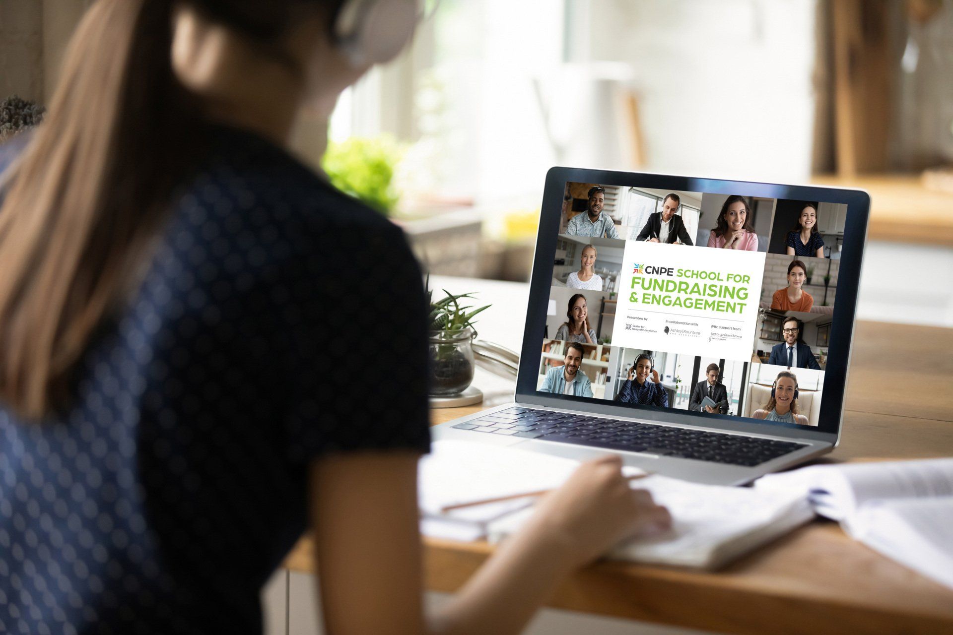 Women working on laptop, taking a virtual class
