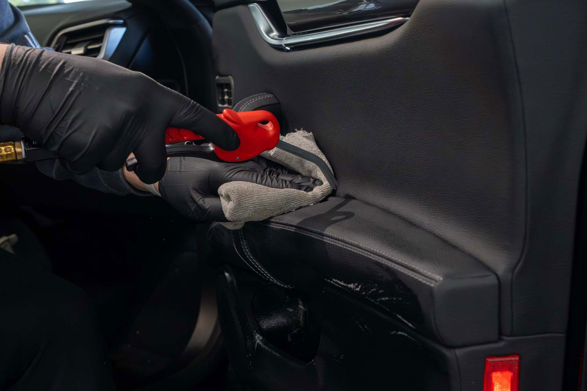 cleaning a car door with a towel .