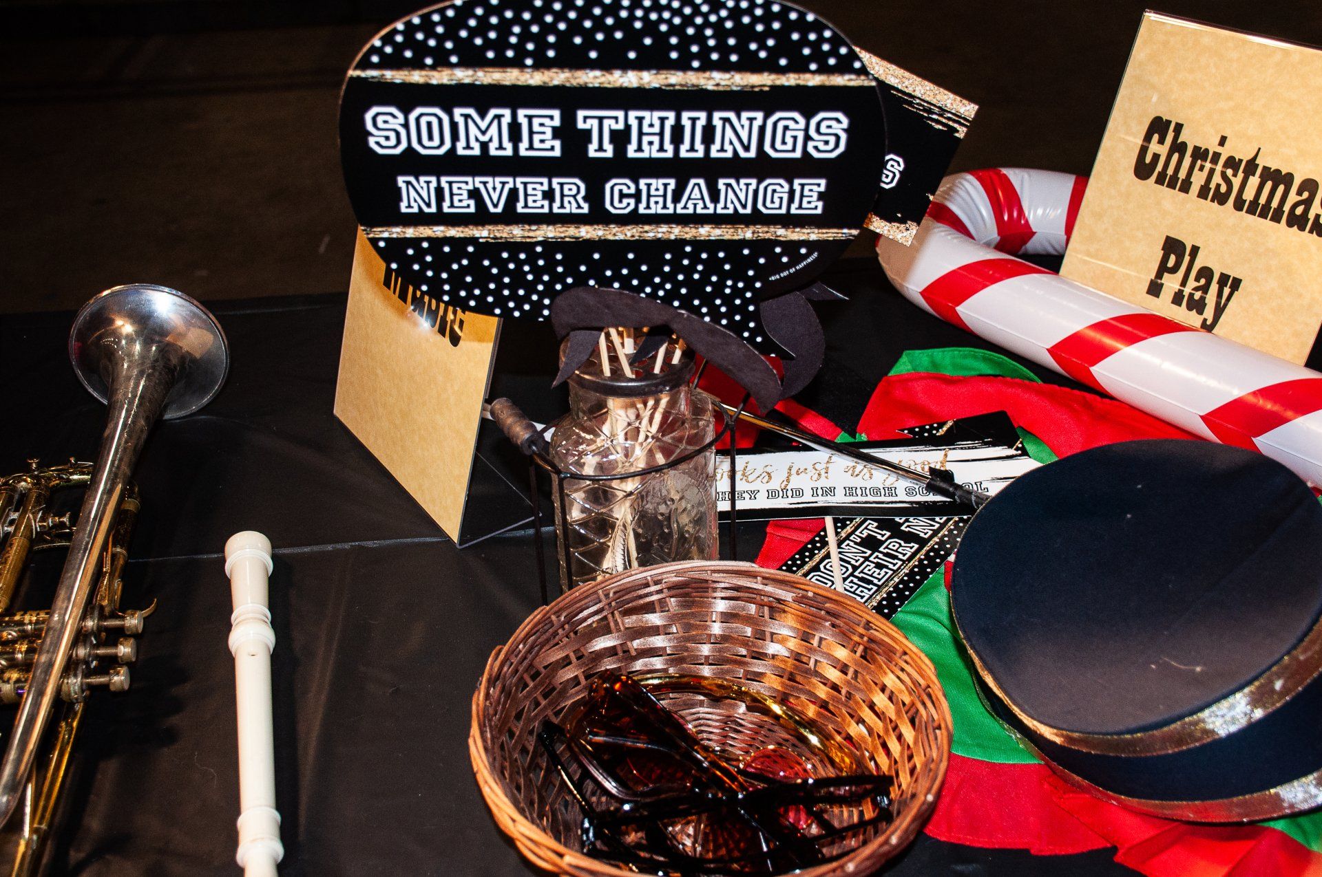 A tabletop display with a sign reading “SOME THINGS NEVER CHANGE,” holiday decor, and assorted small objects