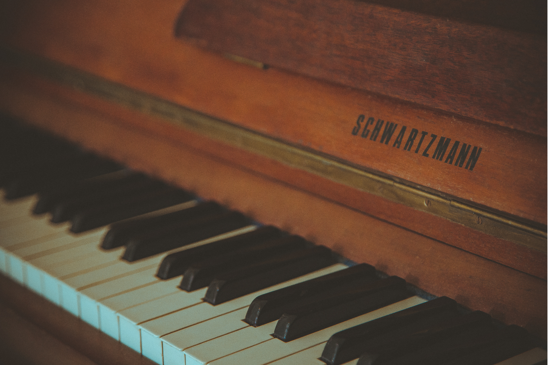 Close-up of a wooden piano keyboard with black and white keys