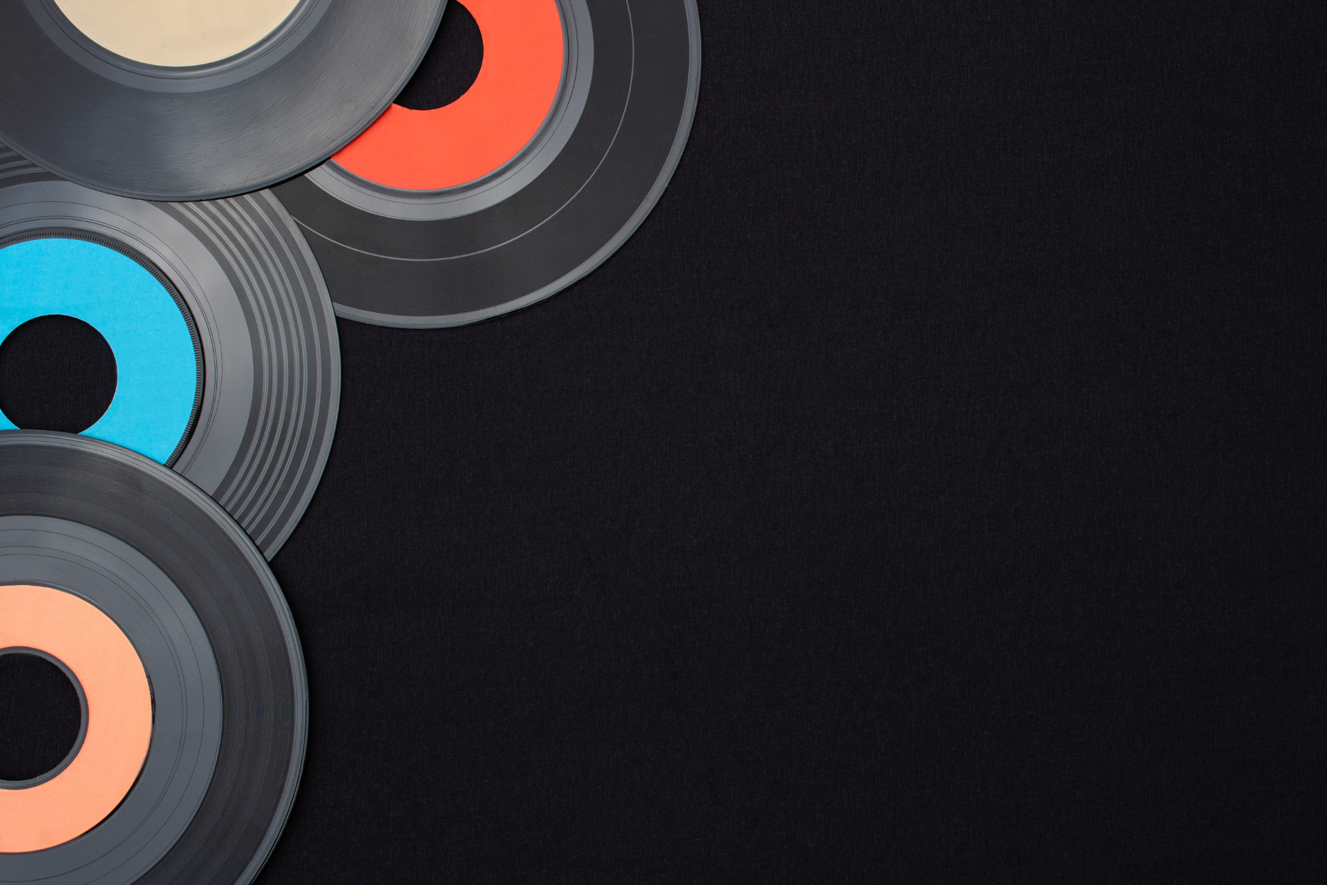 Abstract vinyl records stacked on the left against a dark textured background