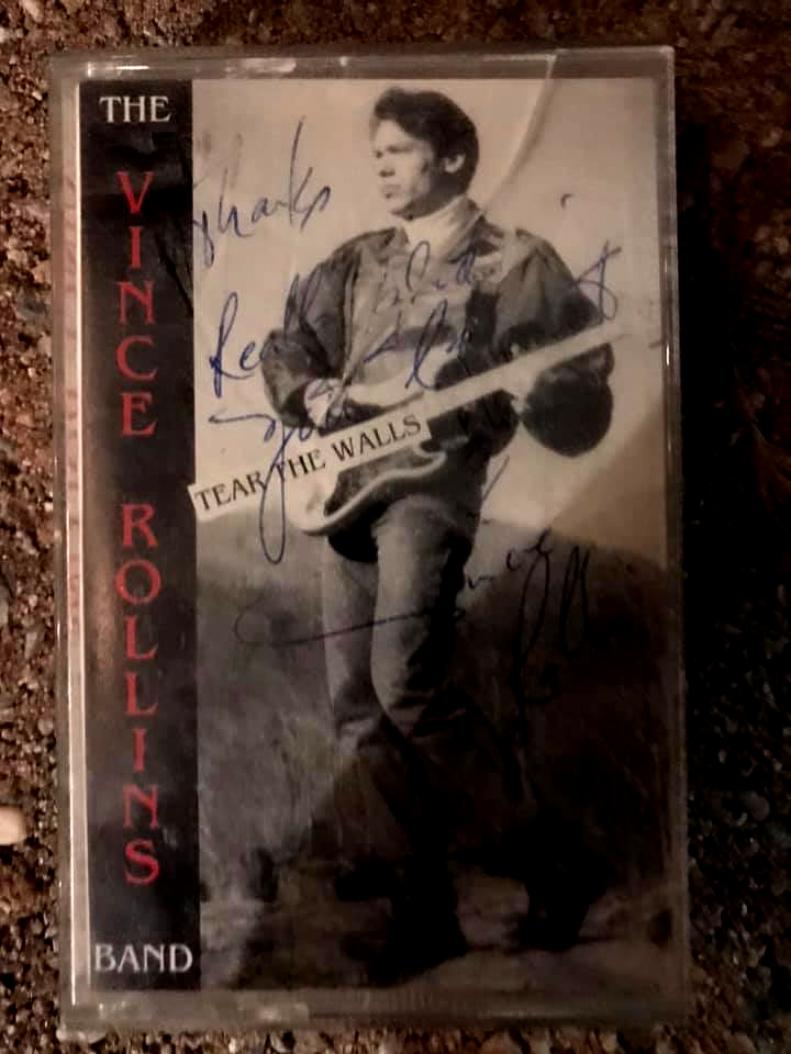 Vintage “The Vince Rolls Band” cassette cover with a man holding a guitar and handwritten signatures