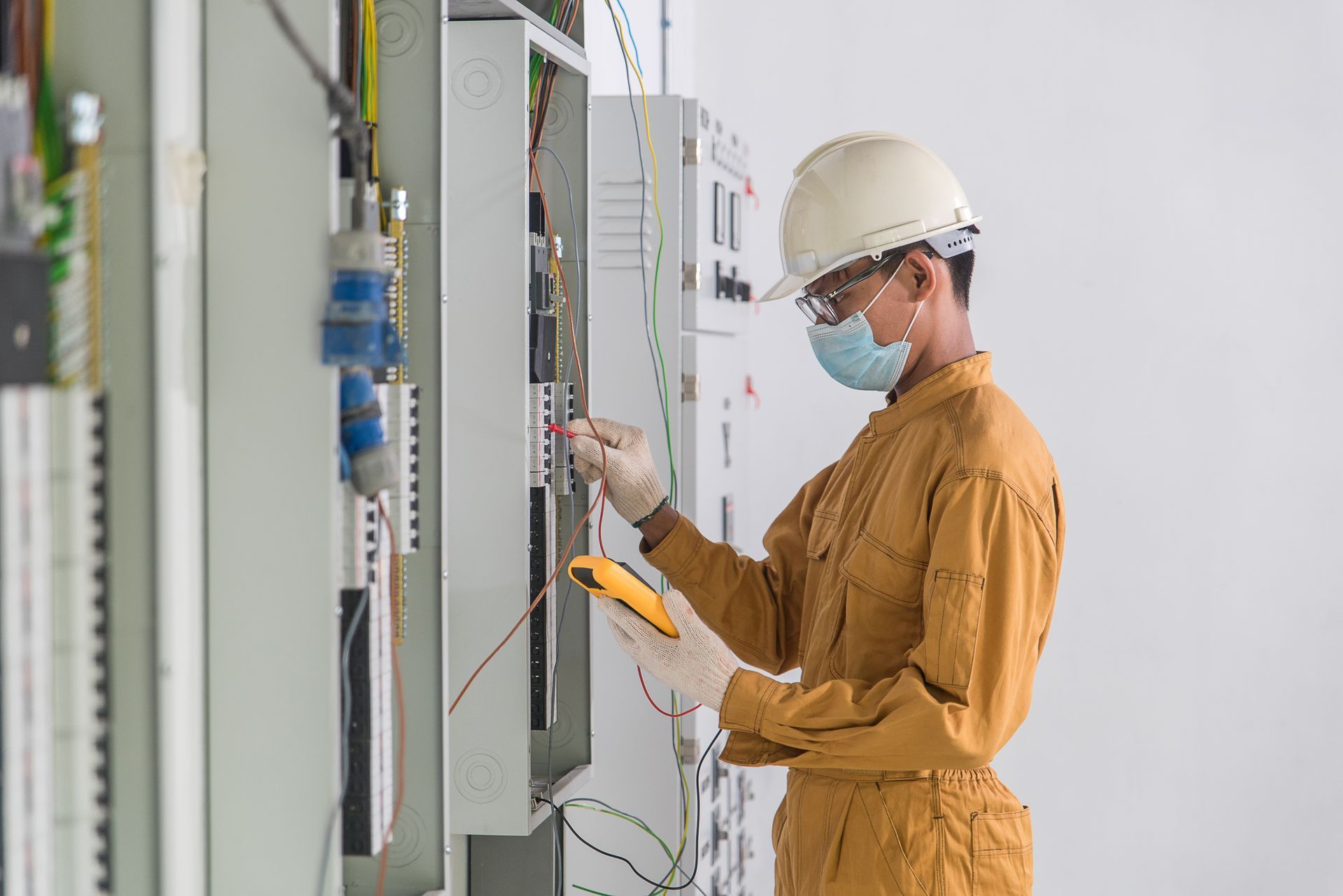 man checking the fire alarm control panel