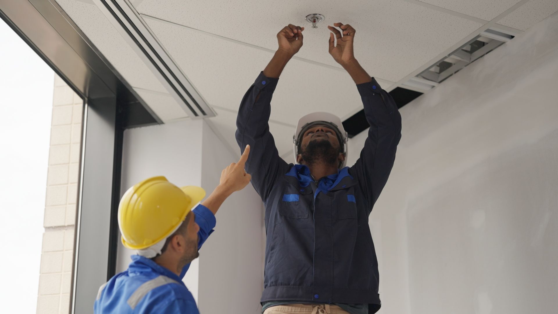 contractors installing a fire sprinkler