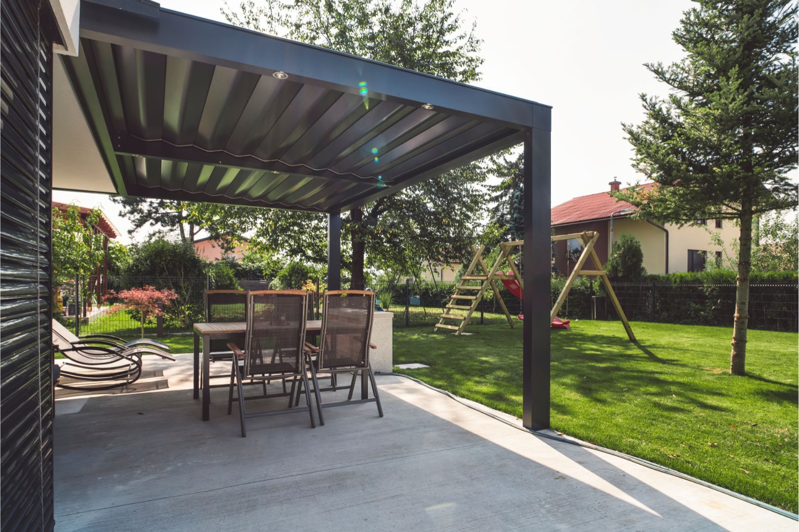 An image of a Concrete Patio in a backyard with patio furniture on the patio in Akron OH