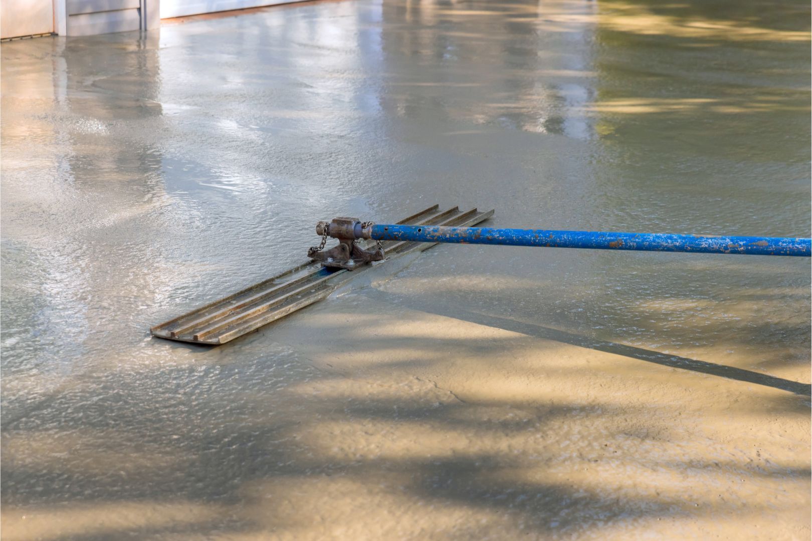 An image of fresh ready mix concrete being smoothed on a new driveway in Akron OH