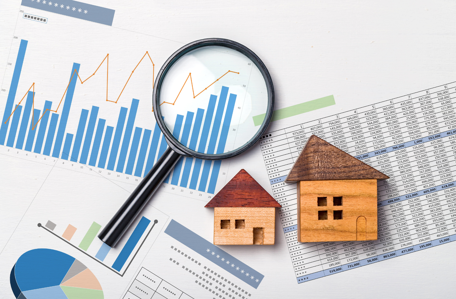 A magnifying glass is sitting on top of a piece of paper next to a model house.
