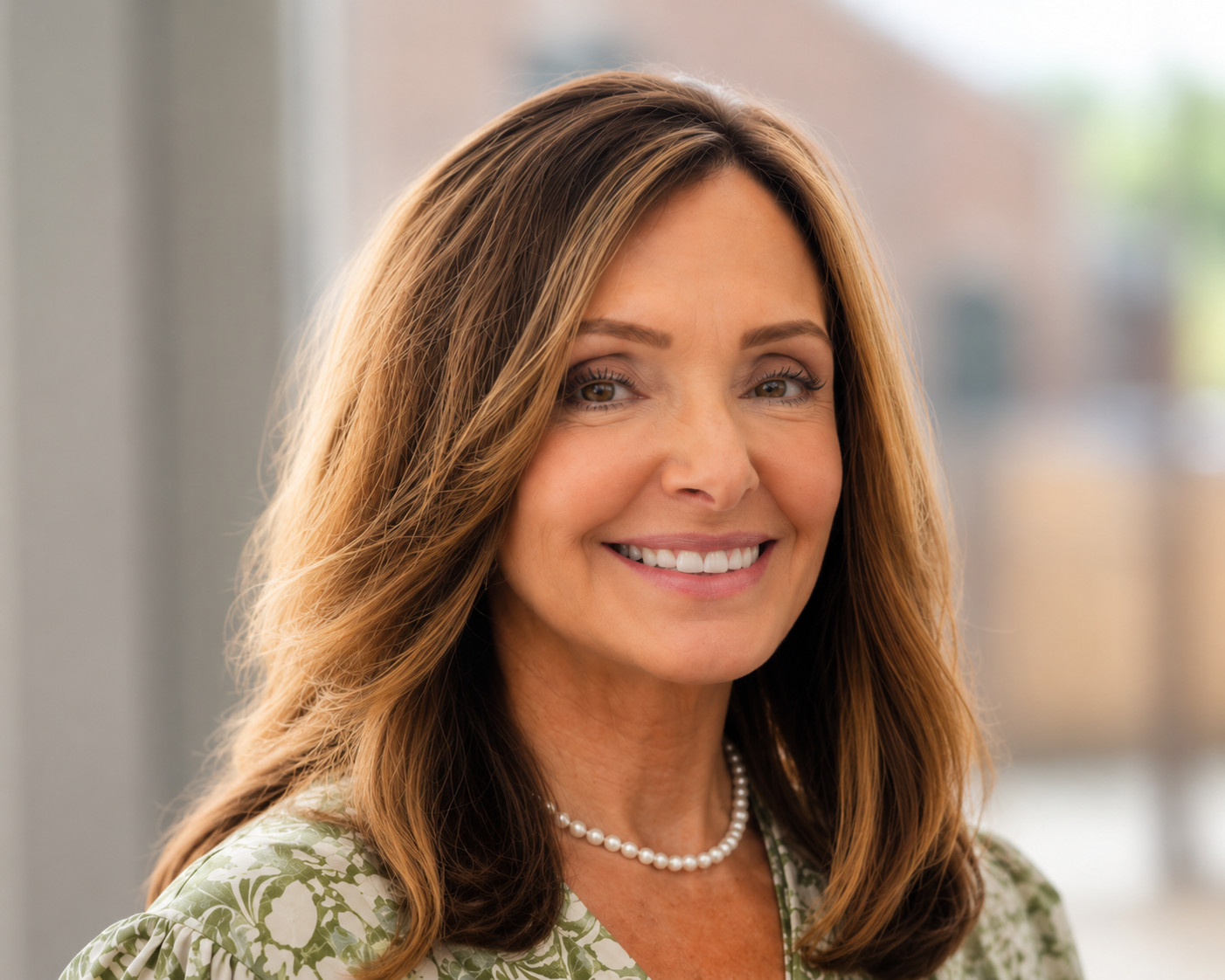 The woman is wearing a black turtleneck and smiling for the camera.
