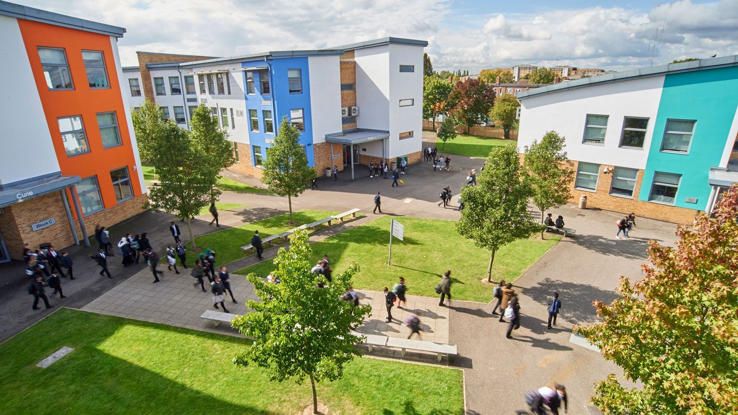 Modern secondary school campus in Greenford with pupils in the grounds