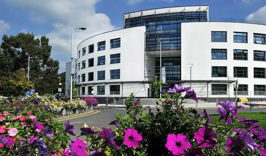 Modern white office building with summer flower displays in Uxbridge