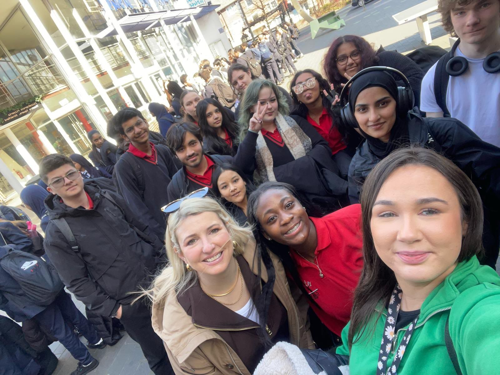 Students and staff taking a group selfie outside a school in Edgware