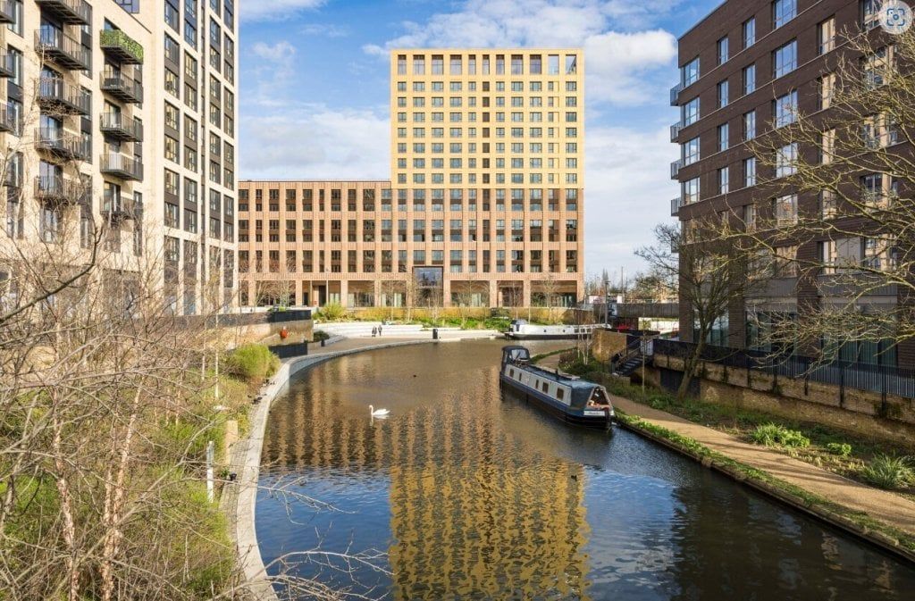 Canal-side apartments at Greenford Quay with a narrowboat on the Grand Union Canal