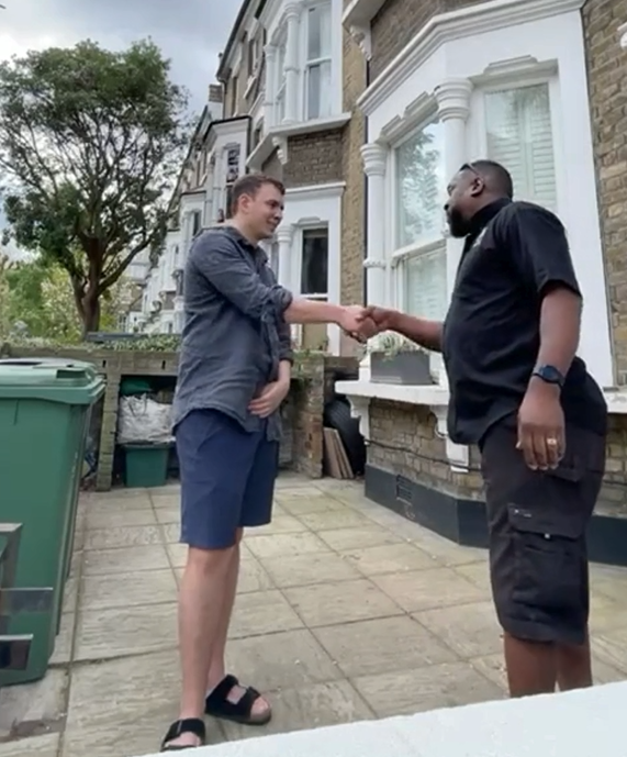 Light Rock Removals mover shaking hands with a customer outside their home
