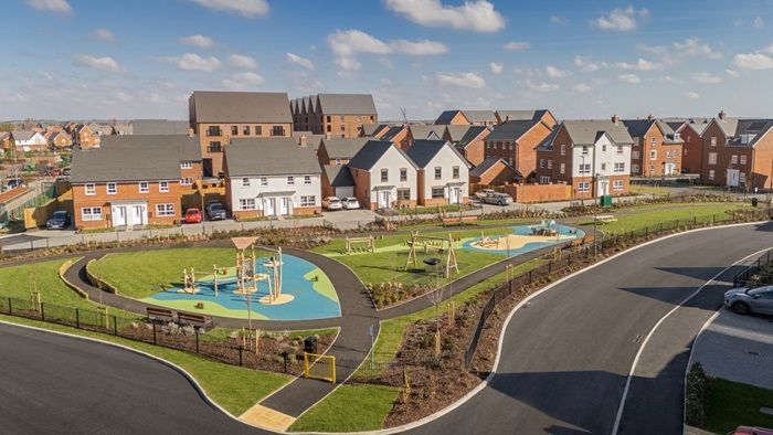 Modern new-build housing estate with a children's play area