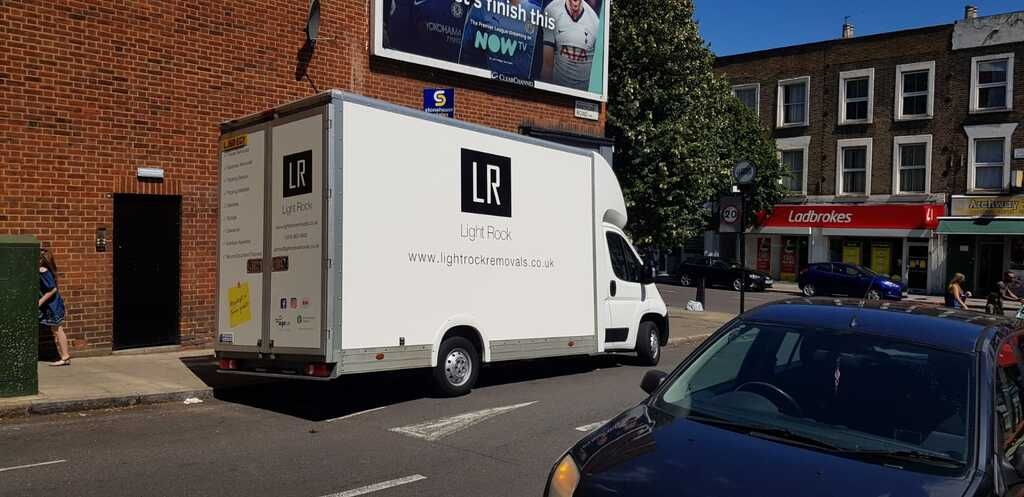 Light Rock Removals Luton van parked on a busy north London high street