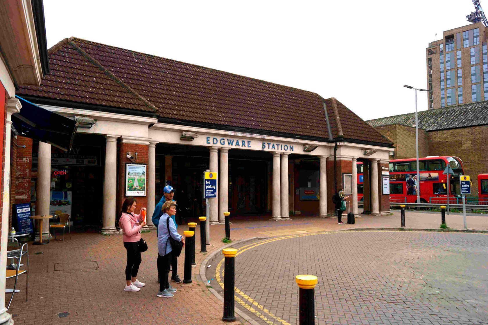 Edgware Underground station entrance with red buses