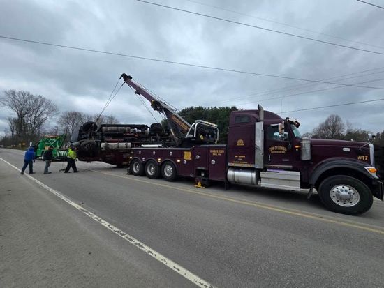 A semi truck is parked in the snow with a trailer attached to it. A semi truck is parked in the snow with a trailer attached to it.