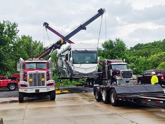 A white car is being lifted by a crane at night. A white car is being lifted by a crane at night.