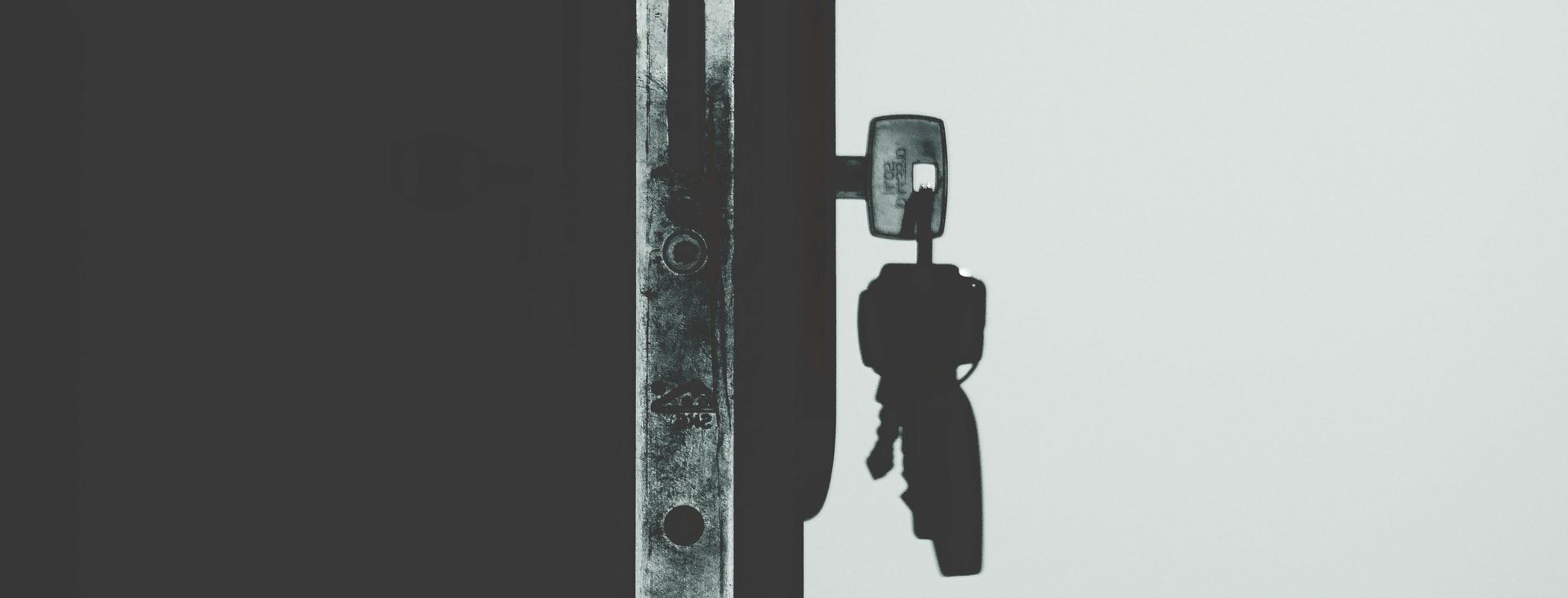 A man is getting out of a truck in the snow.