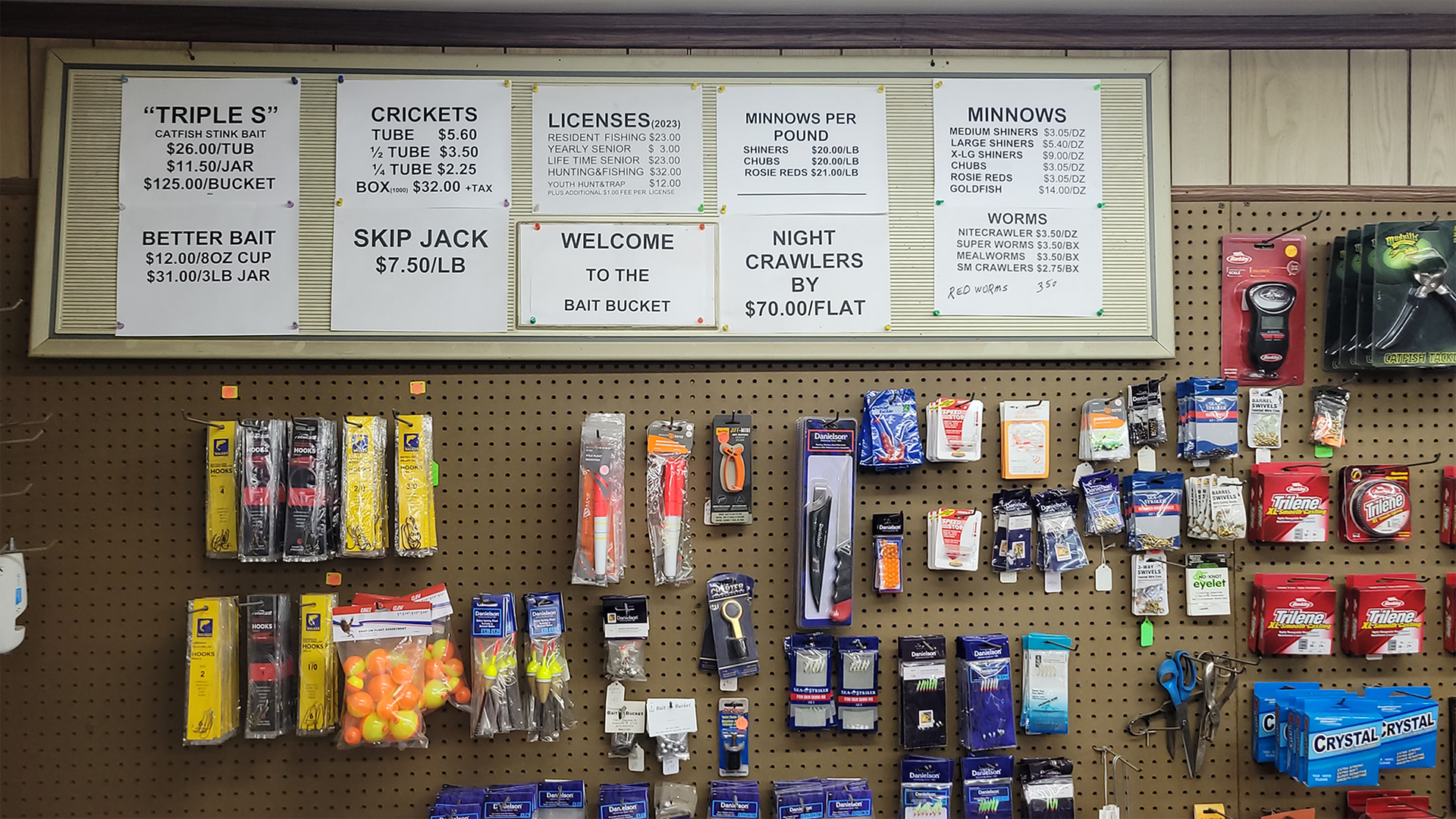 A store display with fishing supplies and handwritten signs.