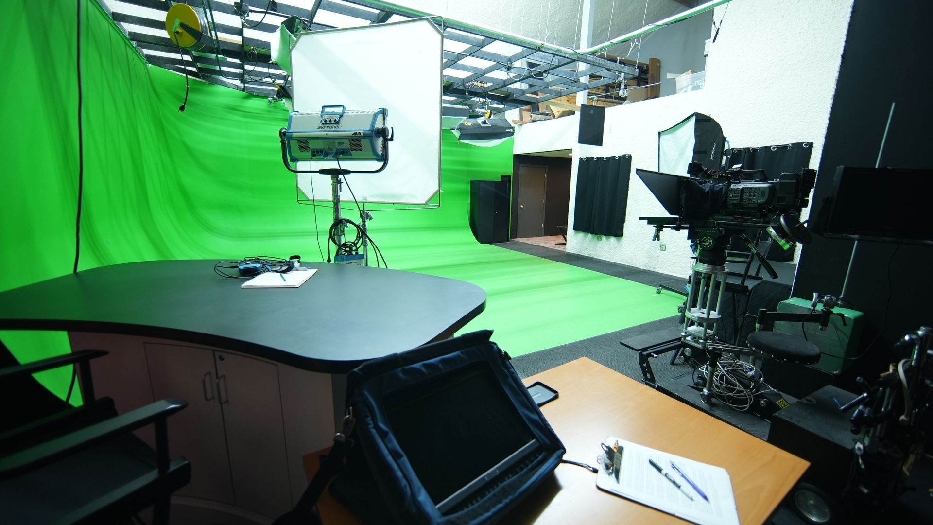 A studio with a green screen and lots of lights.
