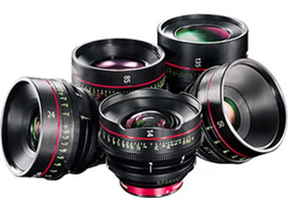 A group of camera lenses are sitting on top of each other on a white background.