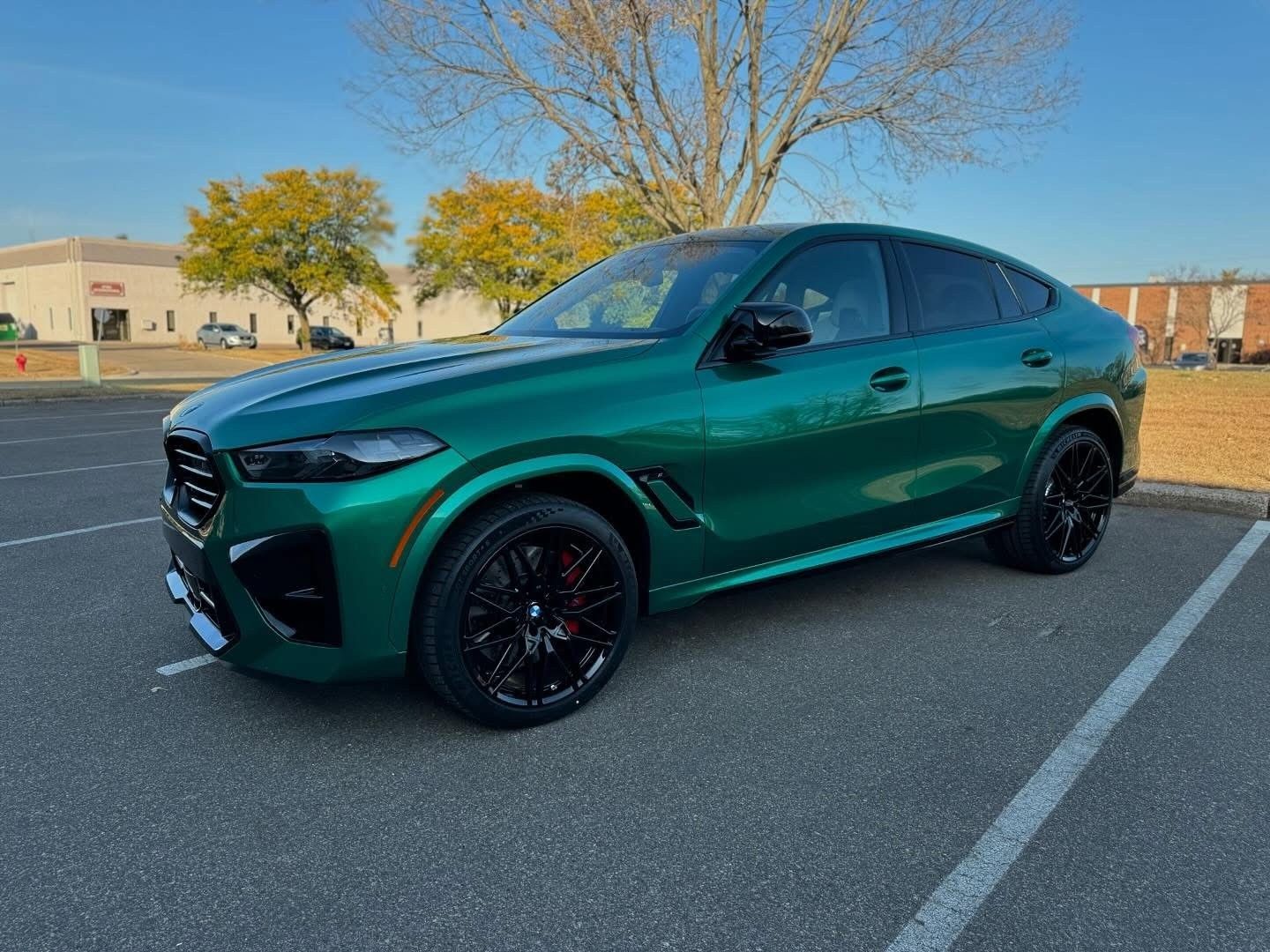 Green sports SUV parked in a lot on a sunny day