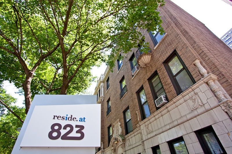 a sign that reads reside at 823 in front of a building