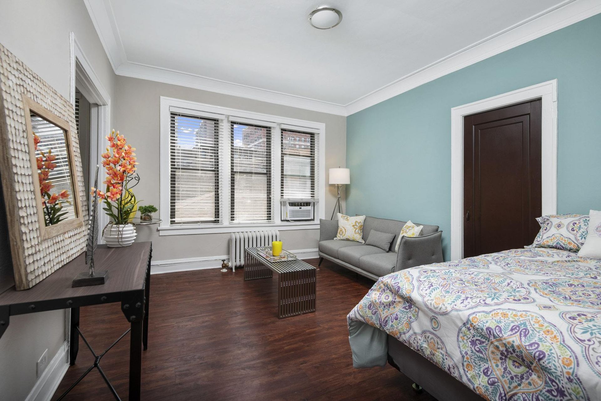 a bedroom with a bed and a couch