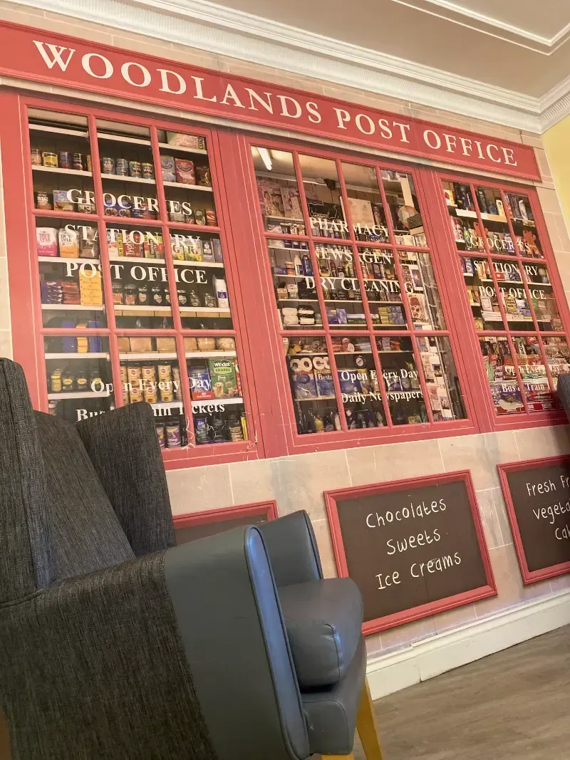 Woodlands Manor Care Home | A waiting room with a woodlands post office mural on the wall.