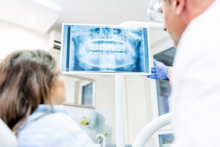 Smiling middle age woman at the dentist for preventative dental care