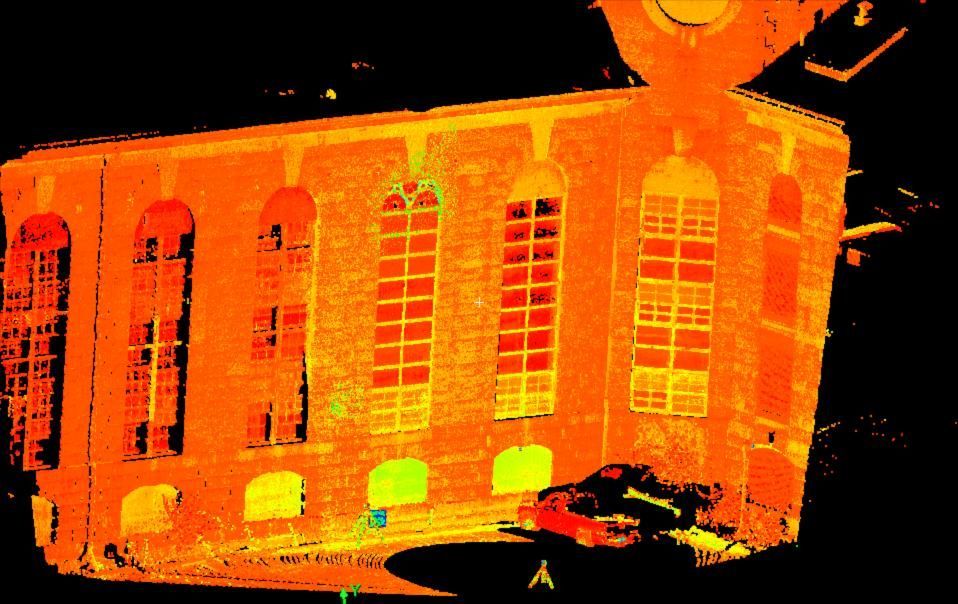 Orange-lit building with tall arched windows against a dark background