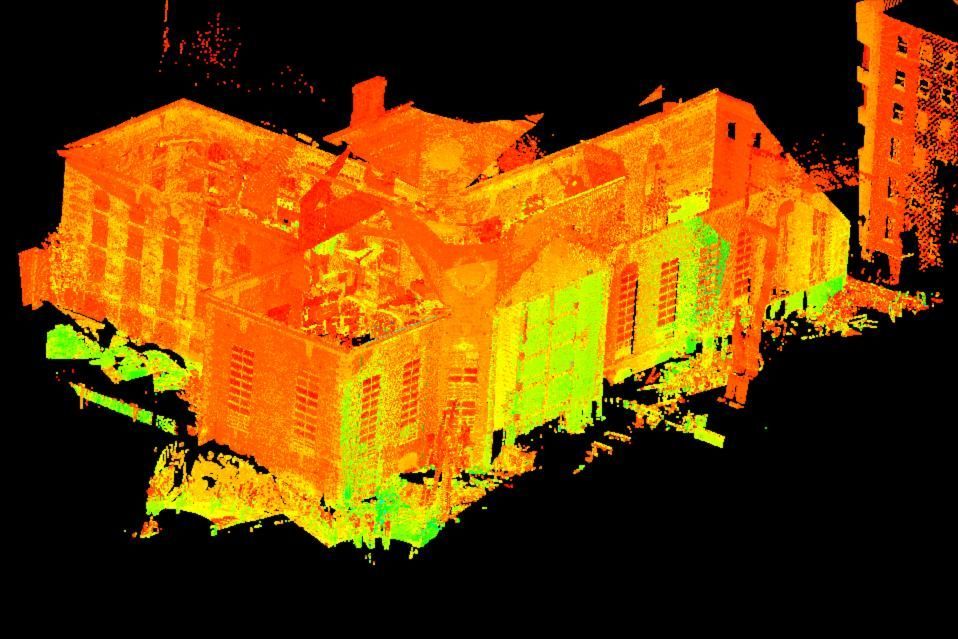 Orange and green 3D scan of a large house against a black background