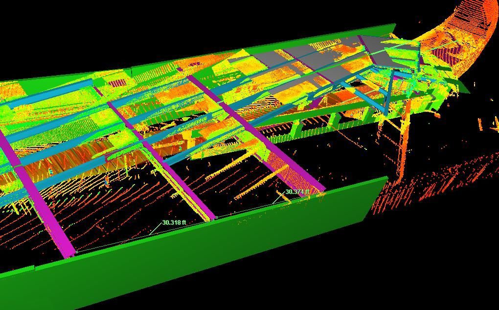 Colorful 3D point-cloud scan of a large structure with green, purple, and orange lines on a black background