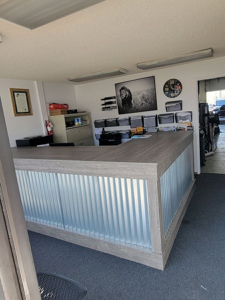 A large metal counter in a room with a wooden counter top.