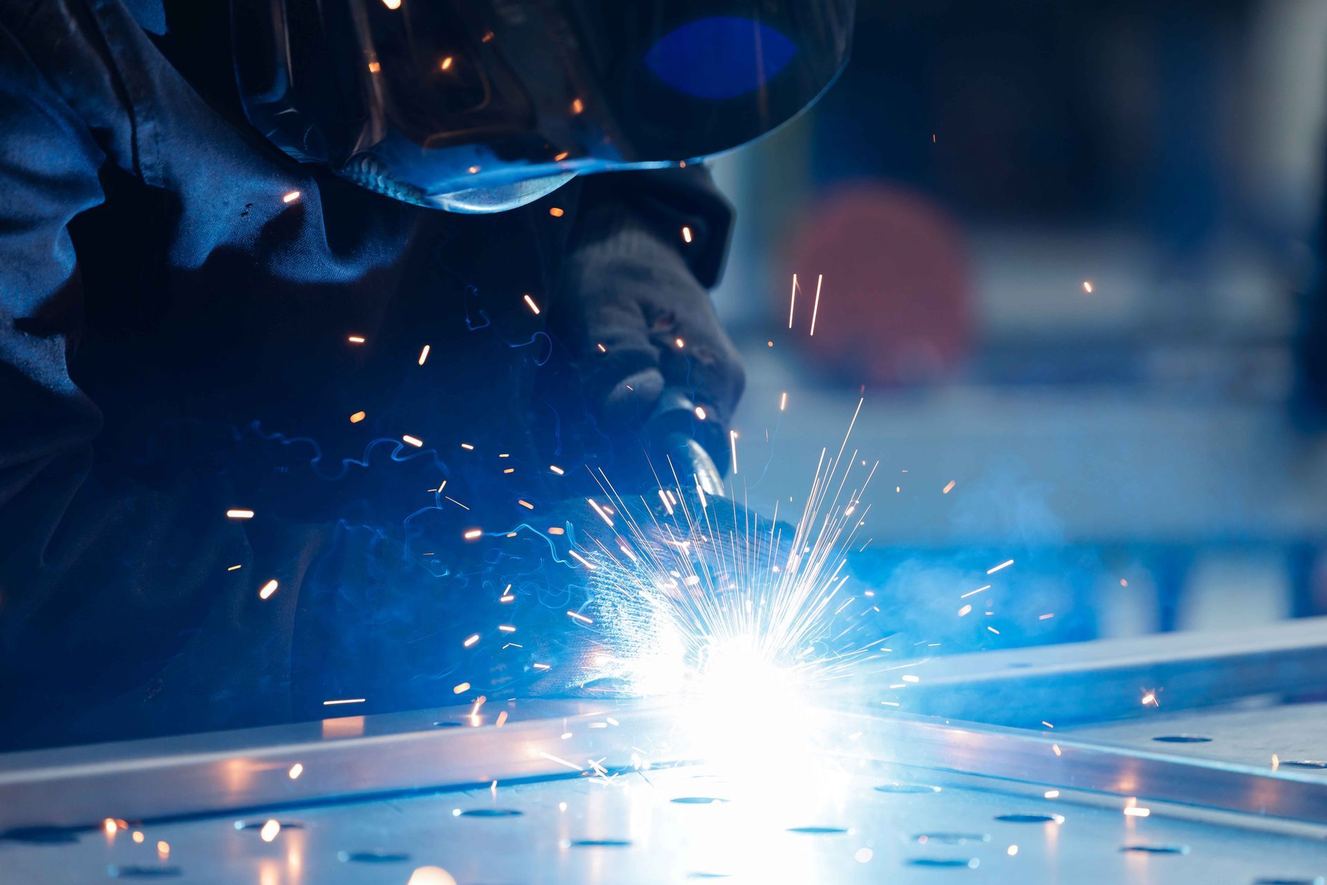 Skilled welder fabricating steel components with precision for industrial construction projects.