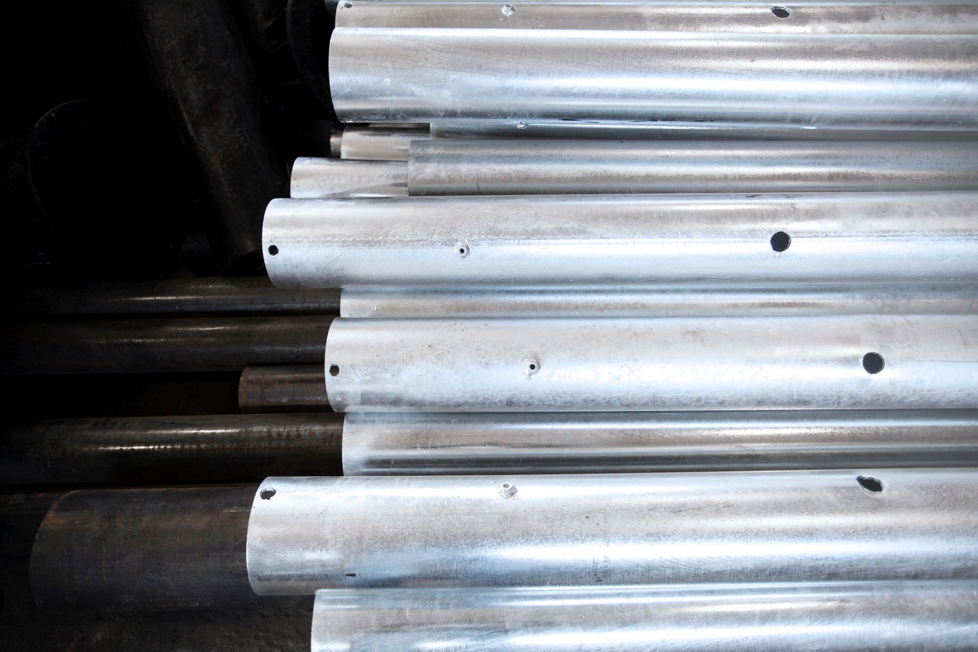 Galvanized steel pipes stacked in inventory, ready for fabrication and industrial applications.
