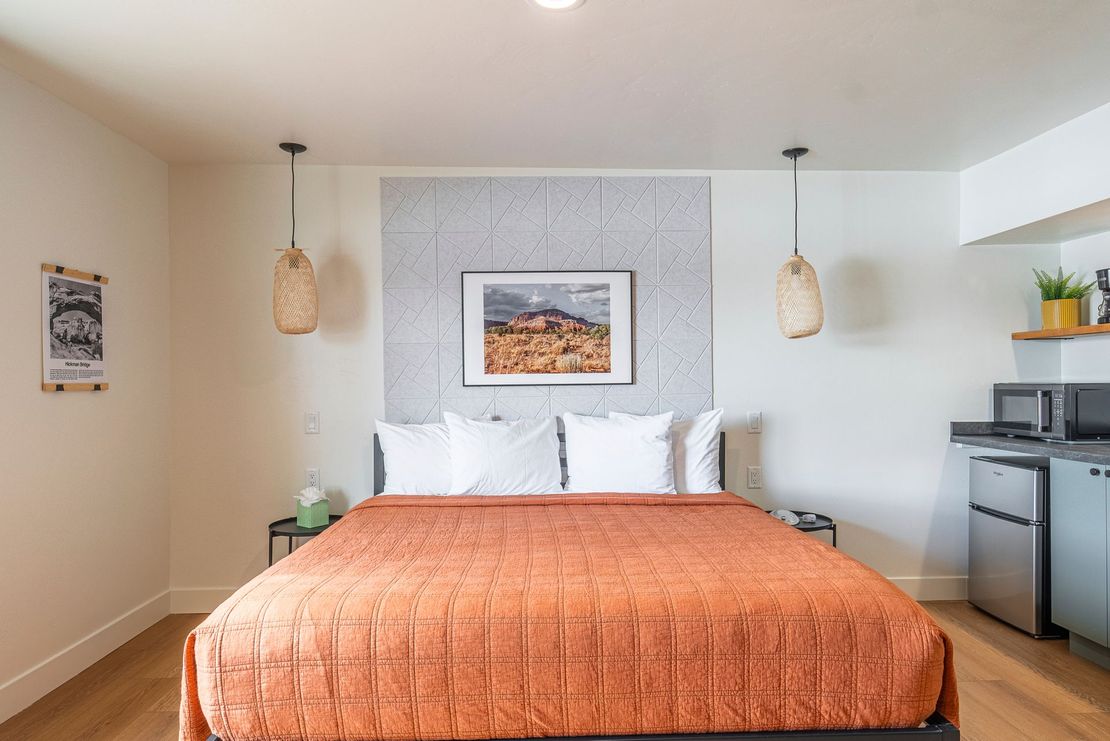 a hotel room with a king size bed and a kitchen .
