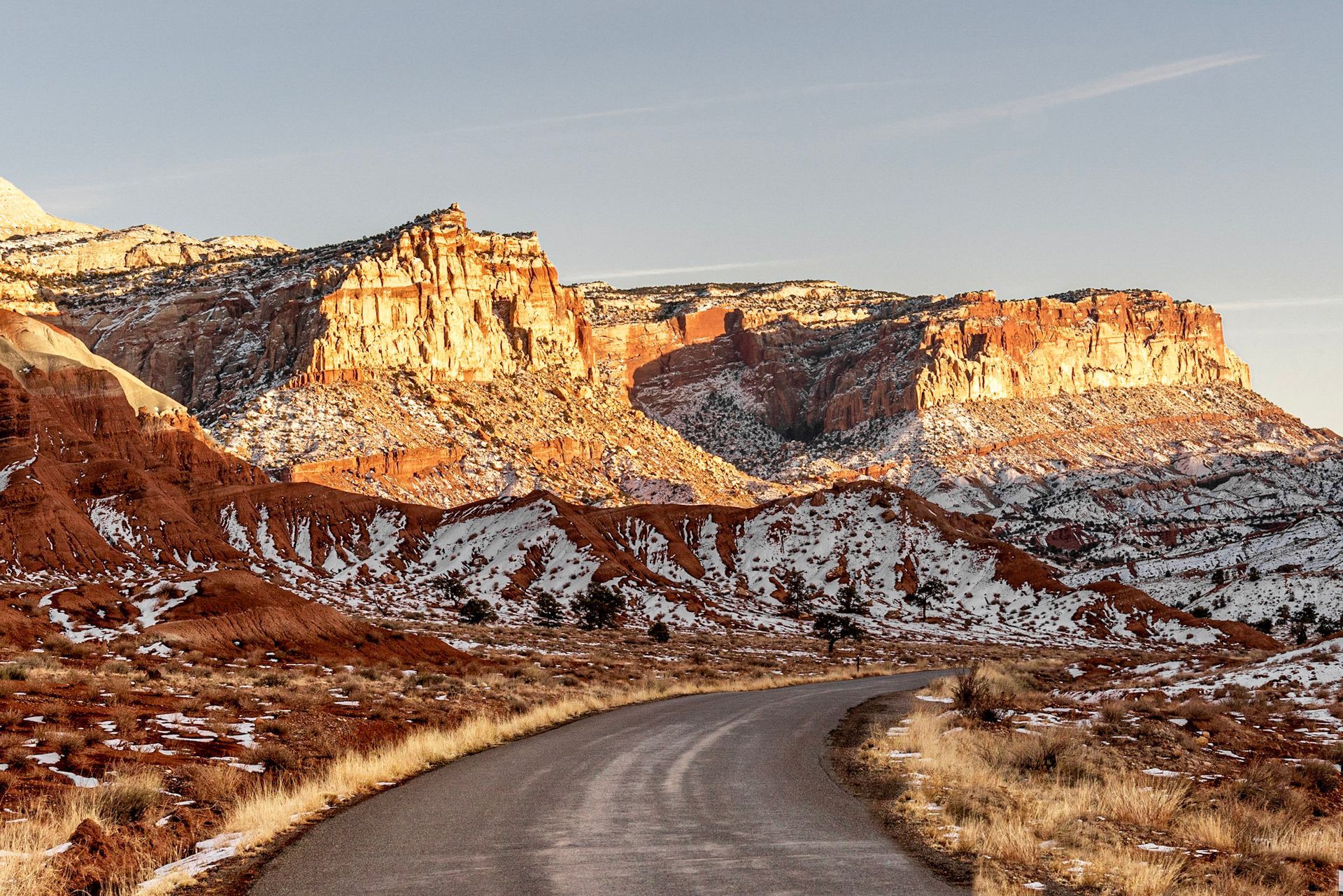 a road in the desert with mountains in the background