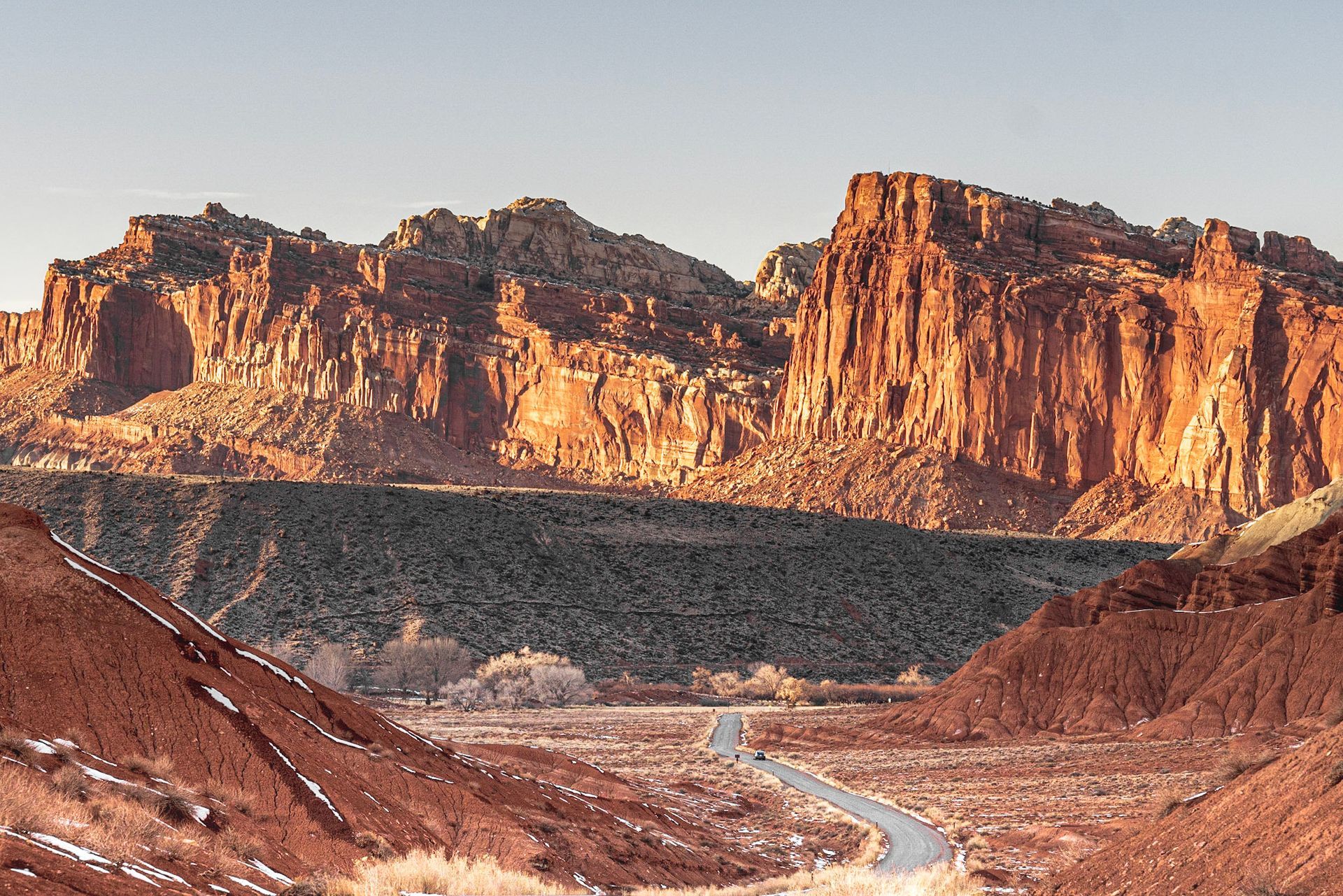 a road in the desert with mountains in the background
