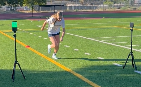 Athlete running through SmartSpeed timing gates during a speed assessment