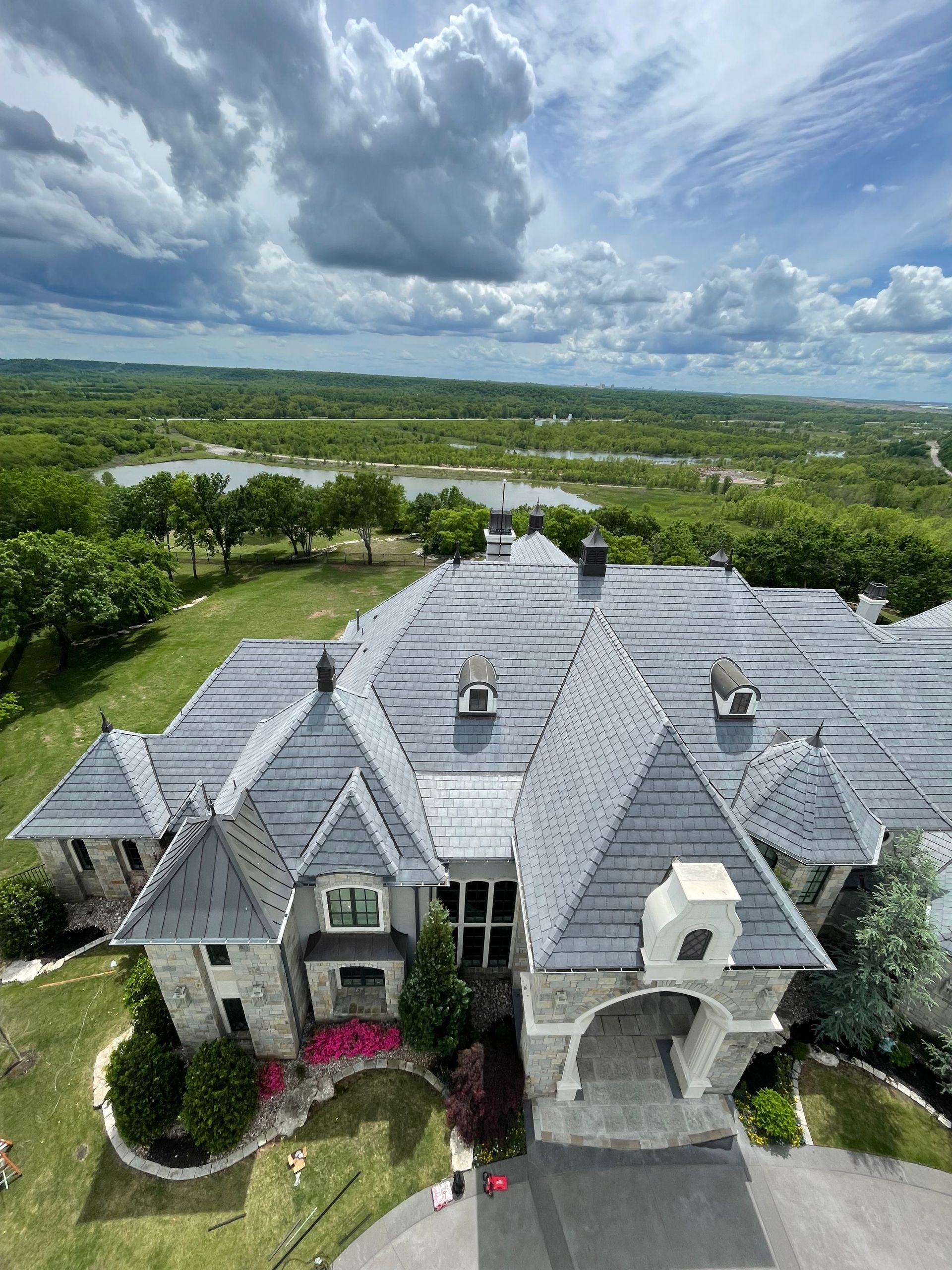 Aerial view of a luxury home in Oklahoma with CMCE system installed on top By Encore Land & Sea