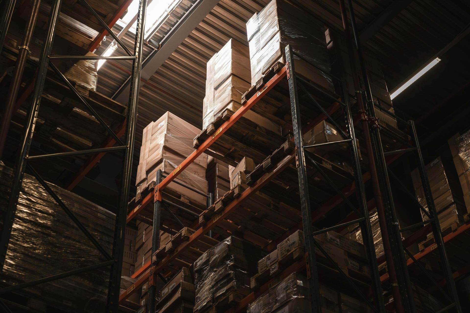 A warehouse filled with lots of boxes on shelves.