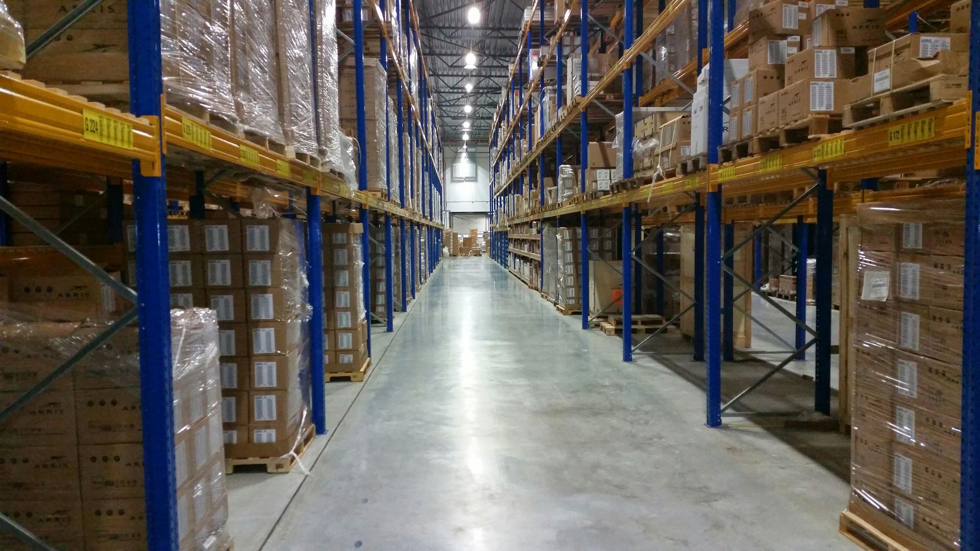 A large warehouse filled with lots of boxes and shelves.