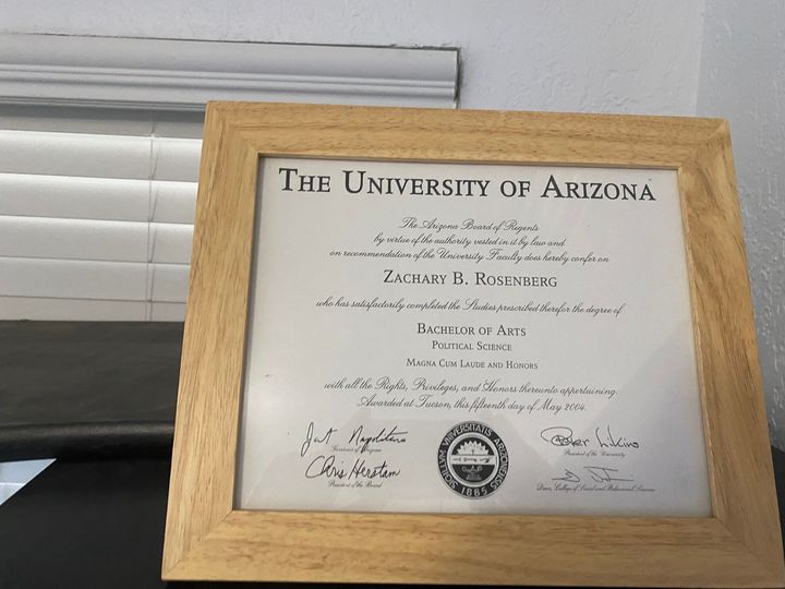 A diploma from the university of arizona in a wooden frame