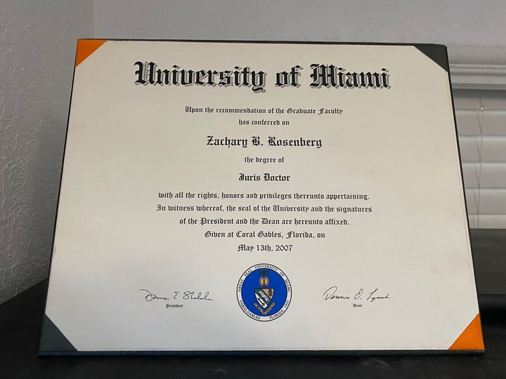 A diploma from the university of miami sits on a table