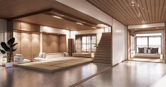 Modern Japanese-style interior with wooden paneling, a raised tatami mat area, and a staircase leading up.