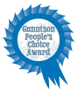 Blue rosette award badge reading “Gunnison People’s Choice Award”