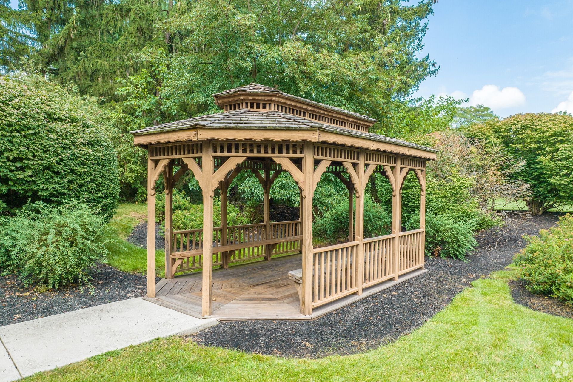 Wooden gazebo in a landscaped garden area of a residential community. Visit us at Fox Ridge & Lakeview Park Apartments and view our modern, garden-style 1 and 2 bedroom apartments in Limerick, PA.