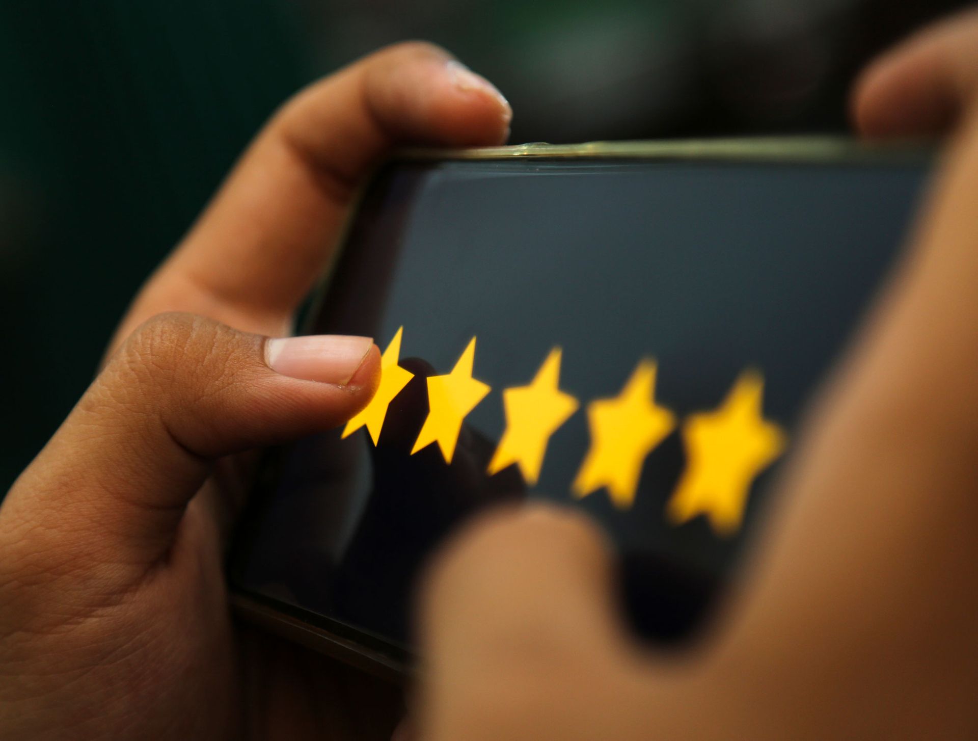 Attractive Hands Showing Five Stars Rating On A Smart Phone — Green Bay, WI — Brabazon Law Office LLC Attractive Hands Showing Five Stars Rating On A Smart Phone — Green Bay, WI — Brabazon Law Office LLC